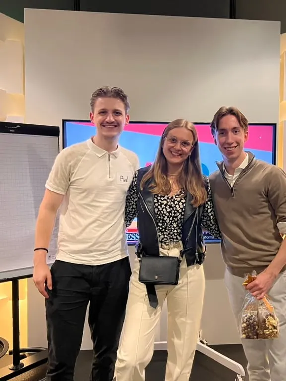 Three of the team standing together at a business event in Tilburg.